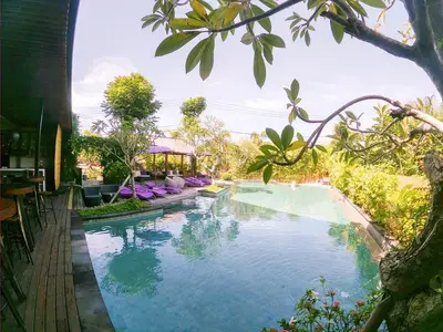 a swimming pool in a resort with a swimming pool at Palm Light Nusa Dua in Nusa Dua