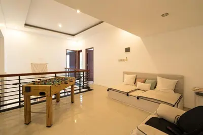 a living room with a table and a couch at Villa Zambrud Sanur Elegant Tropical Villa with Private Pool & Garden and Garage in Sanur