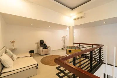 a living room with a couch and a table at Villa Zambrud Sanur Elegant Tropical Villa with Private Pool & Garden and Garage in Sanur