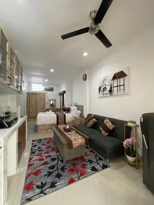 a living room with a couch and a bed at Beachview Residence in Seminyak