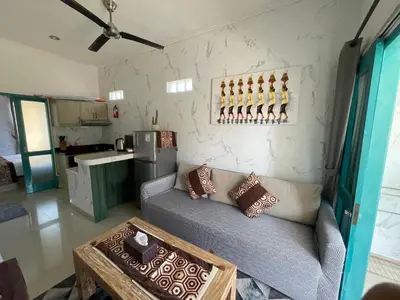a living room with a couch and a table at Beachview Residence in Seminyak