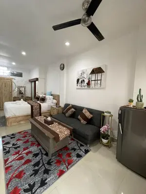 a living room with a couch and a bed at Beachview Residence in Seminyak