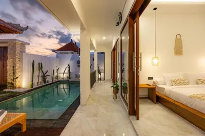 a villa with a swimming pool and a bedroom at Brand New Serene Balinese Villa with Private Pool in Kerobokan