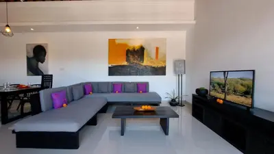 a living room with a couch and a tv at Villa Sofia in Seminyak