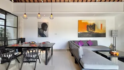 a living room with a couch and a table at Villa Sofia in Seminyak