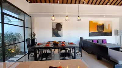 a dining room with a table and chairs at Villa Sofia in Seminyak