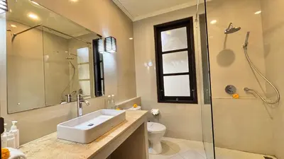 a bathroom with a sink and a shower and a toilet at Villa Sofia in Seminyak