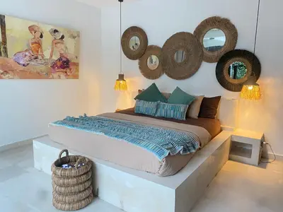 a bedroom with a bed and mirrors on the wall at Seminyak Tropical Oasis Center-3 Br-Private Pool in Seminyak