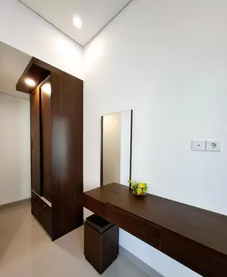 a bathroom with a vanity and a mirror on the wall at Wisman House by Pigeon in Jimbaran