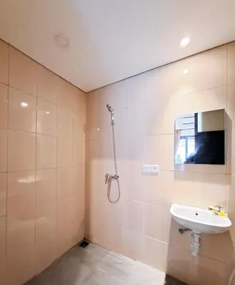 a bathroom with a shower and a sink at Wisman House by Pigeon in Jimbaran