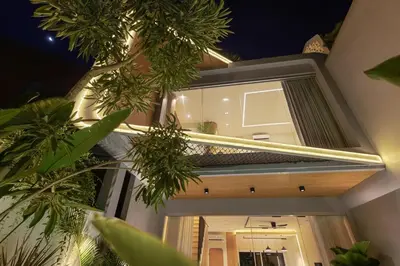 a view of the front of a house at night at New 2BR Architectural Masterpiece in Umalas in Kerobokan