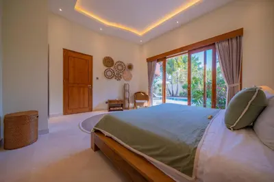 a bedroom with a bed and a large window at 7 BR Luxury Oasis in Seminyak in Seminyak