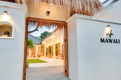 a entrance to a villa with a palm roof at Villa Mawali in Legian