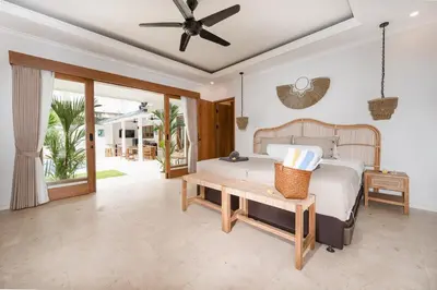 a bedroom with a bed and a ceiling fan at Villa Mawali in Legian