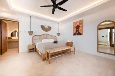 a bedroom with a bed and a ceiling fan at Villa Mawali in Legian