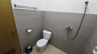 a bathroom with a toilet and a shower stall at Saphala Suites Secondfloor in Seminyak