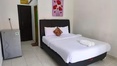 a bedroom with a large bed with white sheets at Saphala Suites Secondfloor in Seminyak