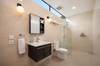 a bathroom with a toilet and a sink and a shower at HUGE 9 BR, 10 BATHR Villa, Best Location near beach in Canggu