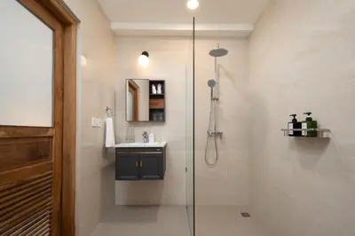 a bathroom with a shower and a sink at HUGE 9 BR, 10 BATHR Villa, Best Location near beach in Canggu