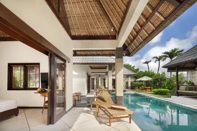 a villa with a swimming pool and a bedroom at HUGE 9 BR, 10 BATHR Villa, Best Location near beach in Canggu