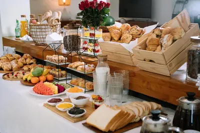 a buffet of bread and pastries on a table at HUGE 9 BR, 10 BATHR Villa, Best Location near beach in Canggu