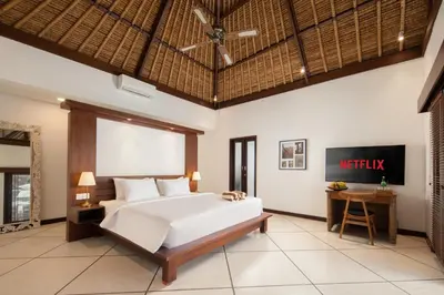 a bedroom with a bed and a ceiling fan at HUGE 9 BR, 10 BATHR Villa, Best Location near beach in Canggu