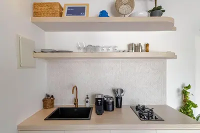 a kitchen with a sink and a counter top at Villa Gael by Pertama Management in Seminyak