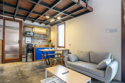 a living room with a couch and a table at First 5 Loft near Seminyak in Seminyak