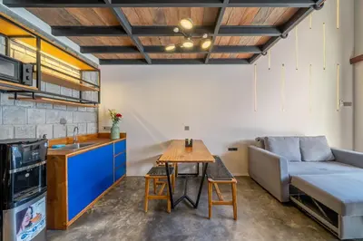 a living room with a couch and a table at First 5 Loft near Seminyak in Seminyak