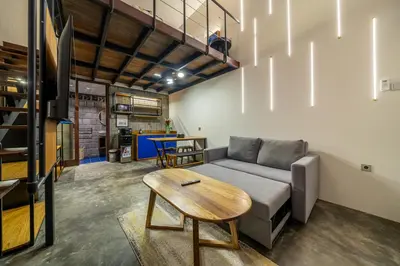 a living room with a couch and a table at First 5 Loft near Seminyak in Seminyak