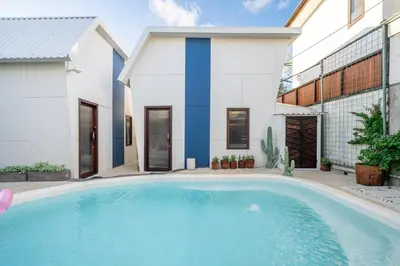 a swimming pool in front of a house at First 5 Loft near Seminyak in Seminyak