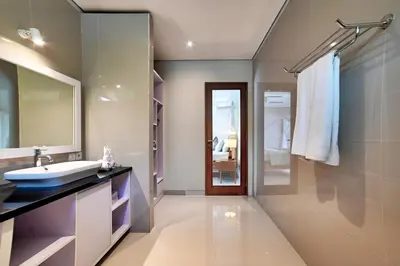 a bathroom with a sink and a mirror at Villa Laskmi Legian in Seminyak