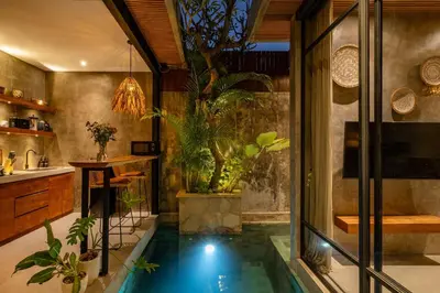 an indoor pool in a bathroom with plants at Romantic Honeymoon Villa - Private Pool & Netflix in Dalung