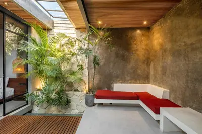 a room with a red bench and plants at Romantic Honeymoon Villa - Private Pool & Netflix in Dalung