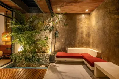 a room with a bench and plants in it at Romantic Honeymoon Villa - Private Pool & Netflix in Dalung