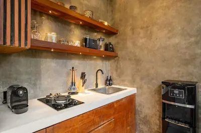 a kitchen with a sink and a stove top oven at Romantic Honeymoon Villa - Private Pool & Netflix in Dalung