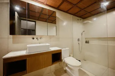 a bathroom with a toilet and a sink and a shower at UrbanVilla in Legian
