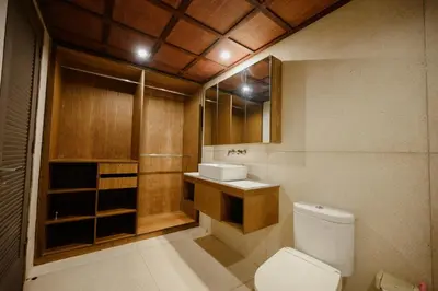 a bathroom with a toilet and a sink at UrbanVilla in Legian