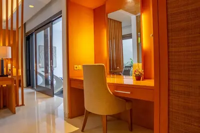 a room with a desk with a chair and a mirror at Jineng Febe G Villa in Seminyak