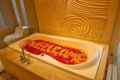 a bath tub filled with food in a bathroom at Jineng Febe G Villa in Seminyak