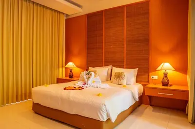 a bedroom with a bed with a stuffed animal on it at Jineng Febe G Villa in Seminyak