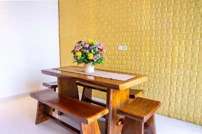 a table with a vase of flowers on it at Jineng Febe G Villa in Seminyak