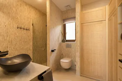 a bathroom with a toilet and a black bowl sink at Cozy Villa Alami 2BR Sanur beachside in Sanur
