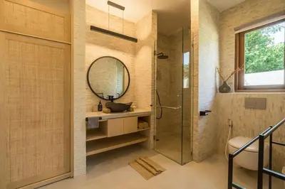 a bathroom with a shower and a sink and a mirror at Cozy Villa Alami 2BR Sanur beachside in Sanur