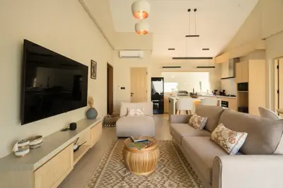 a living room with a large flat screen tv at Cozy Villa Alami 2BR Sanur beachside in Sanur