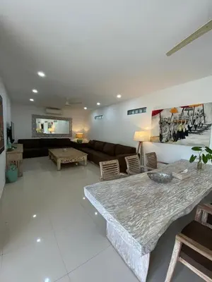 a living room with a couch and a table at Luxury 3 BR Elegant intertior Perfect for group in Kerobokan