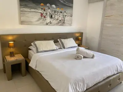 a bedroom with a large bed with two towels on it at Luxury 3 BR Elegant intertior Perfect for group in Kerobokan