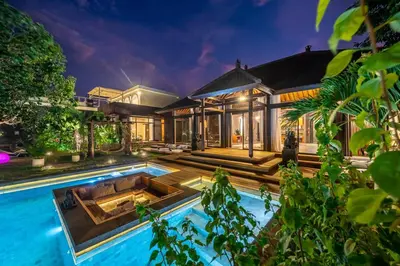 an exterior view of a house with a swimming pool at Exclusive 4BR Villa Kito - Cinema, Sauna, Yoga and Pool in Jimbaran