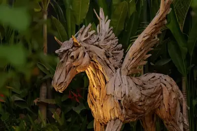 a wooden statue of a horse with at Exclusive 4BR Villa Kito - Cinema, Sauna, Yoga and Pool in Jimbaran