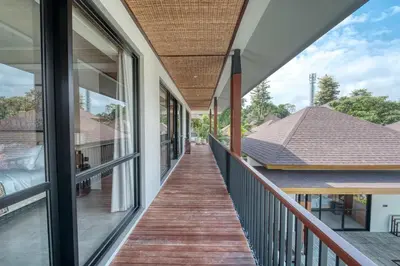 a balcony with a view of a house at Natadesa Villa 3BR Family Villa in Jimbaran in Jimbaran